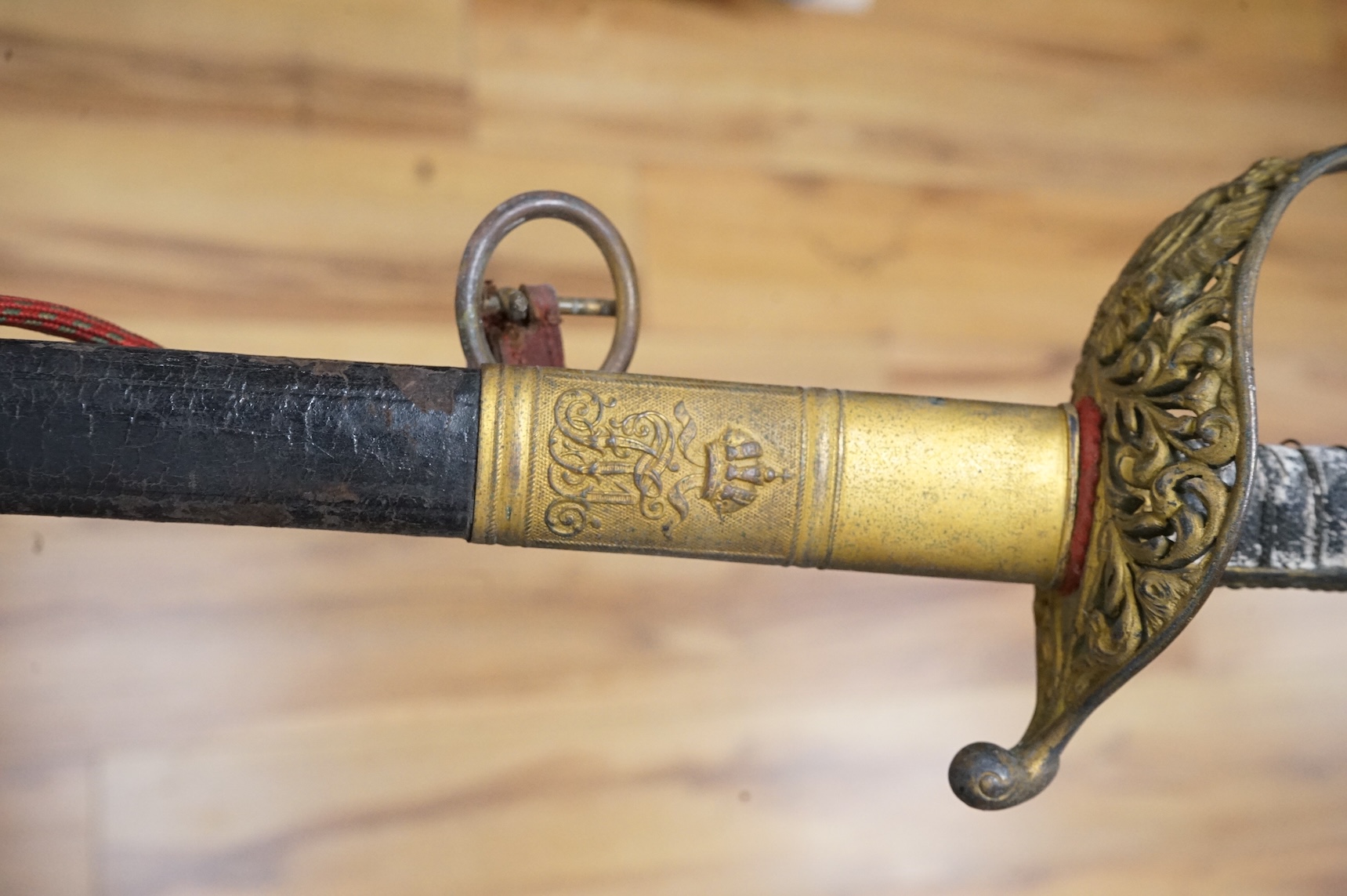 An officer’s sword, three walking sticks and an antique sword stick, longest walking stick 92cm long